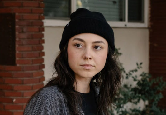 A woman wearing the MiiR Recycled Cashmere Beanie