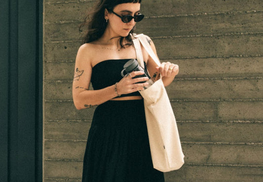 A woman using the MiiR Everyday Canvas Tote