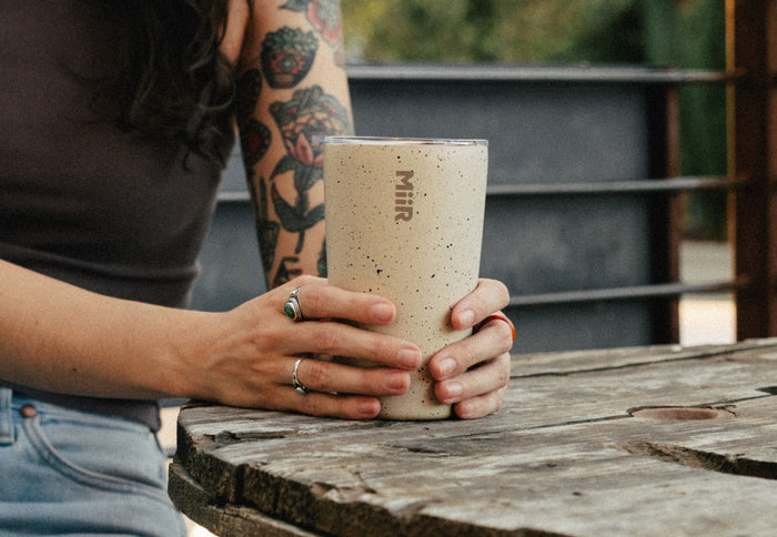 Person holding a MiiR Tumbler in Desert Tan Speckle